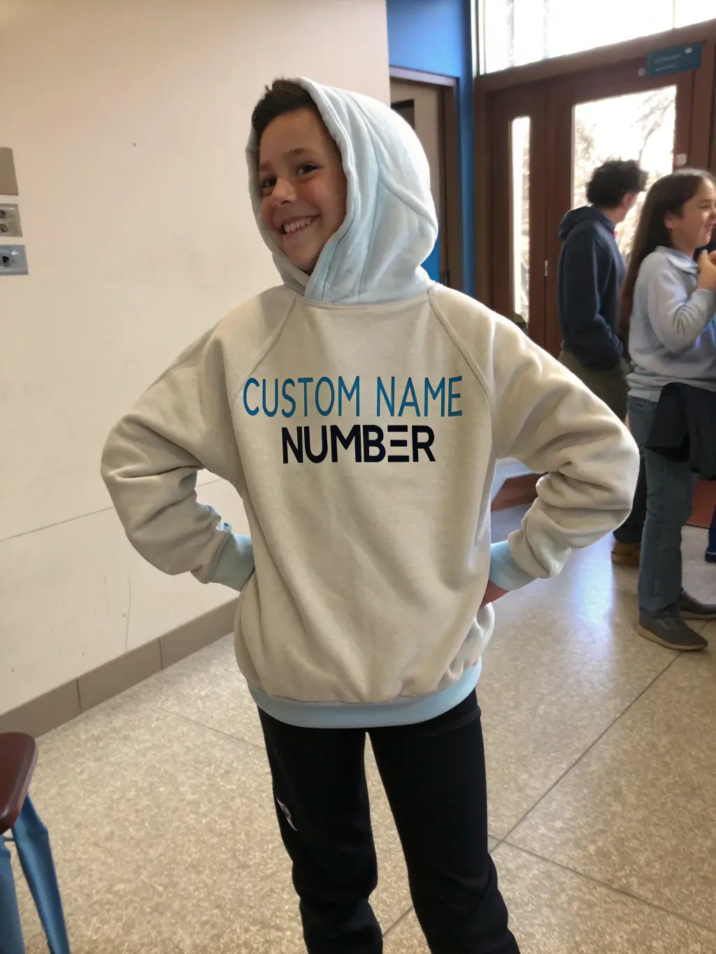 A professional studio shot of a person wearing a custom-designed hoodie with a company logo, emphasizing the comfort, style, and branding opportunities available through PERSONTEES' hoodie customization services.
